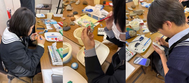 石ころに思い思いの色を塗る生徒たち